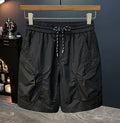 Men's loose fit camouflage cargo shorts with cargo pockets on a mannequin.