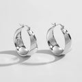 Widened curved stainless steel earrings in gold or steel colour, available in 25mm or 30mm sizes