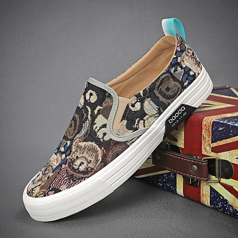 A pair of khaki-coloured canvas slip-on sneakers with a low-top profile, round toe, and vulcanised rubber sole on a plain background.