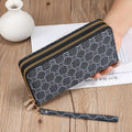 Retro style long wallet clutch in PU leather with a print design, shown in black colour.