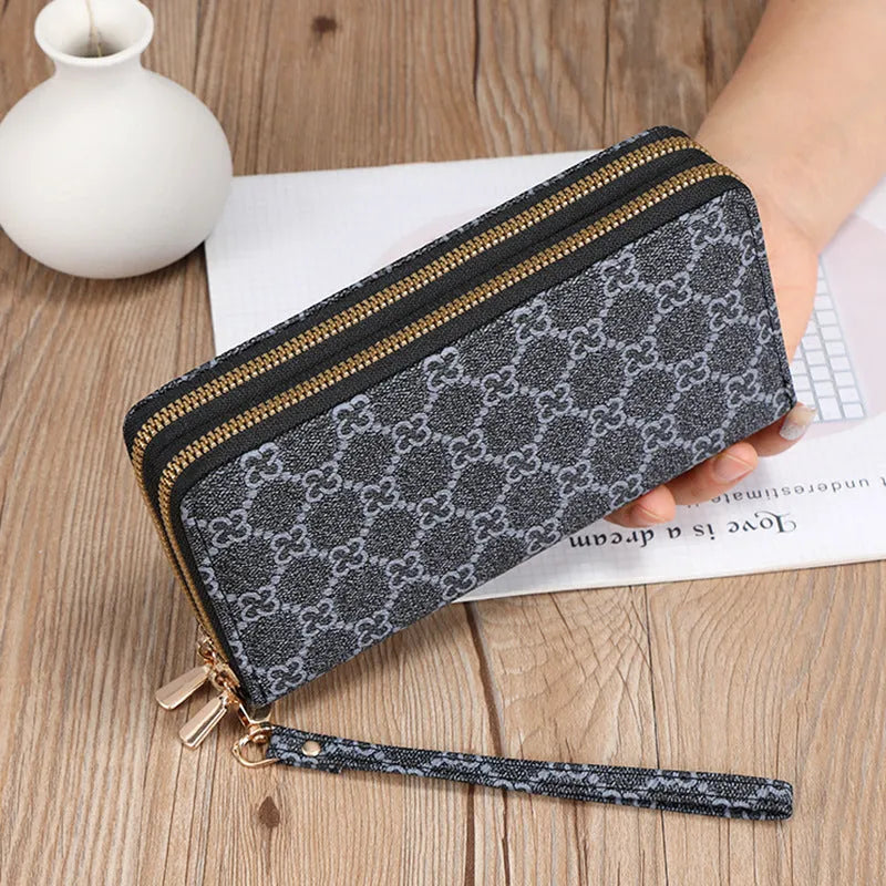 Retro style long wallet clutch in PU leather with a print design, shown in black colour.