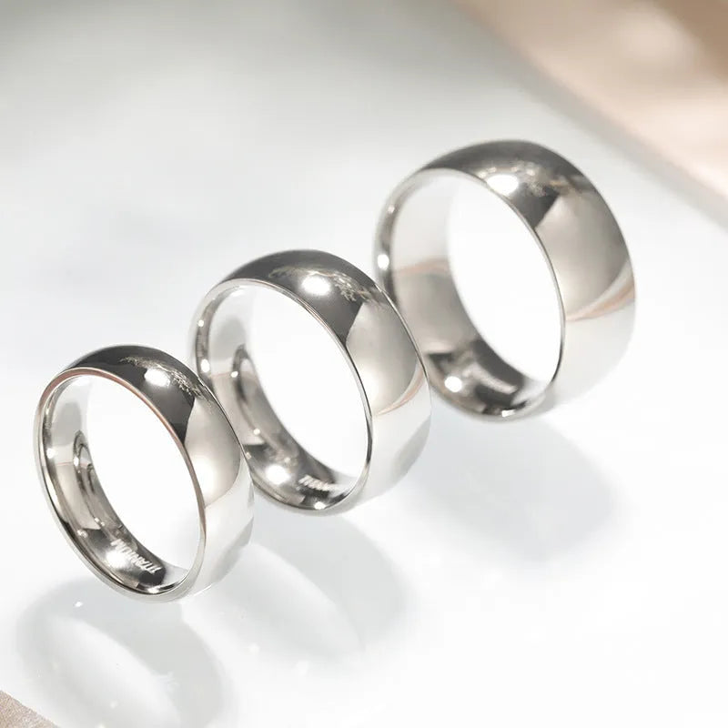 Silver titanium steel ring with grinding finish on finger, showing smooth surface and uniform colour