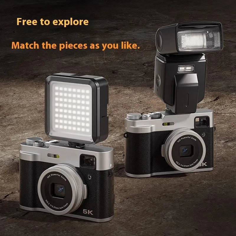 Black 5K HD digital camera with dual lenses, 2.88-inch screen, and optical viewfinder on a table