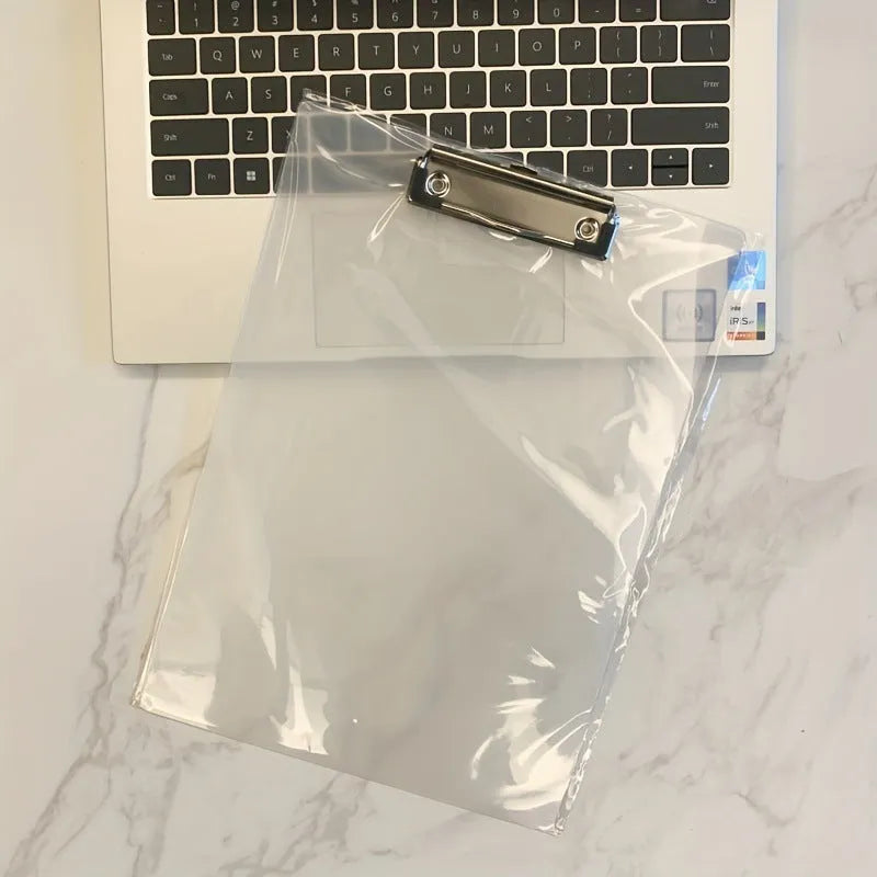 Clear A4 plate holder with metal clip and transparent writing pad in blue colour on a desk.
