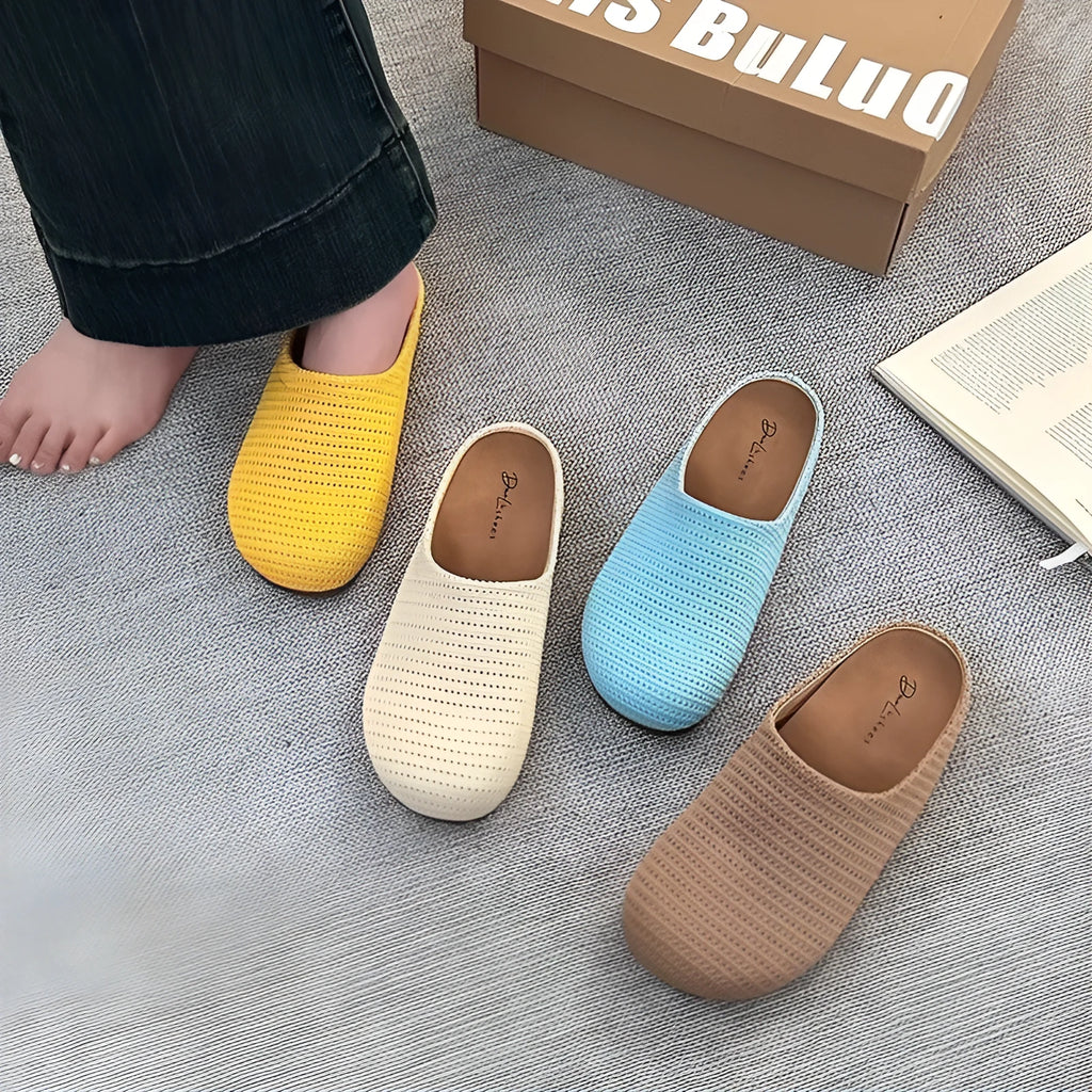 Women's blue cloth slippers with non-slip rubber soles and round toe design shown from side view