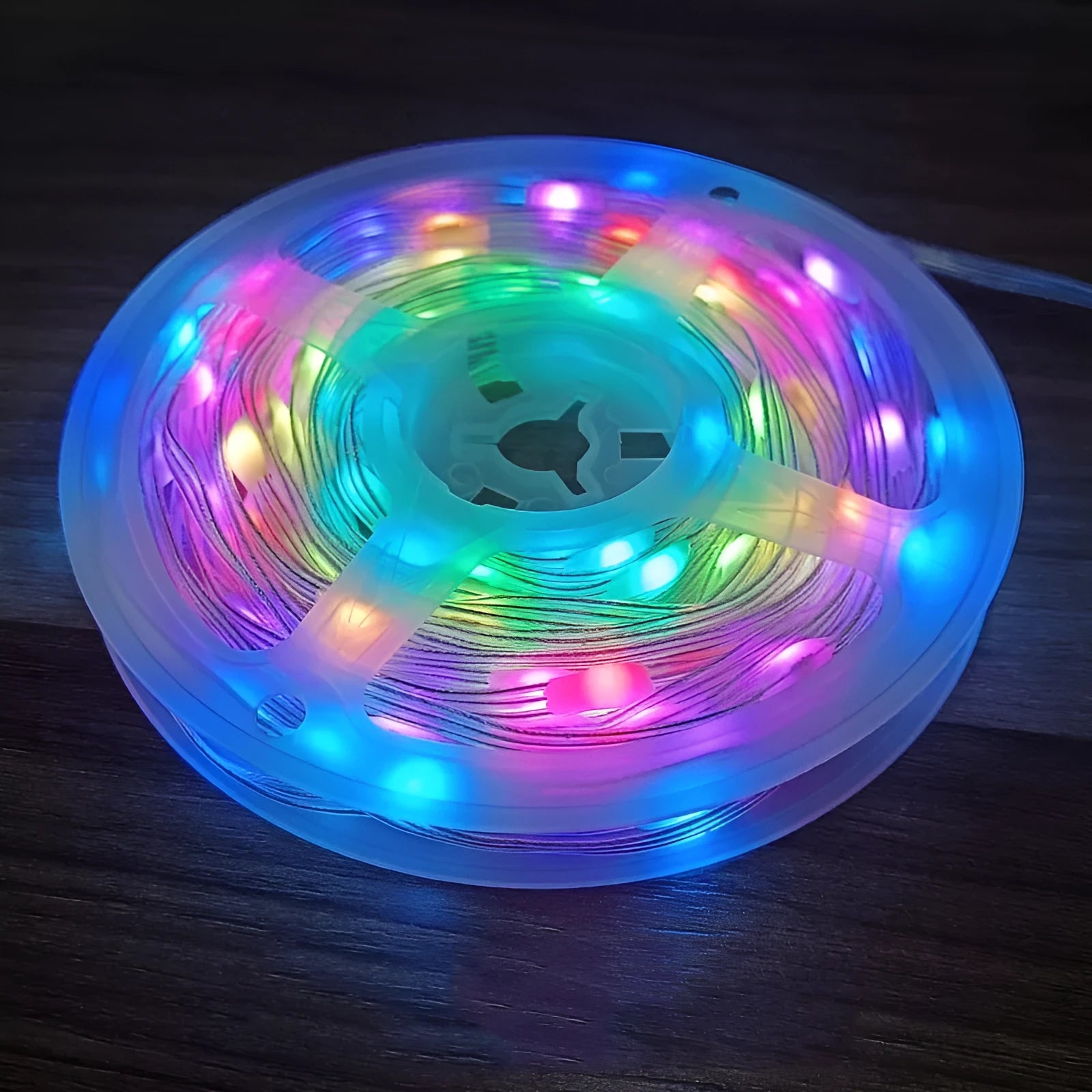 10-metre long flexible LED light string with 100 multi-colour bulbs lit up in a garden setting.