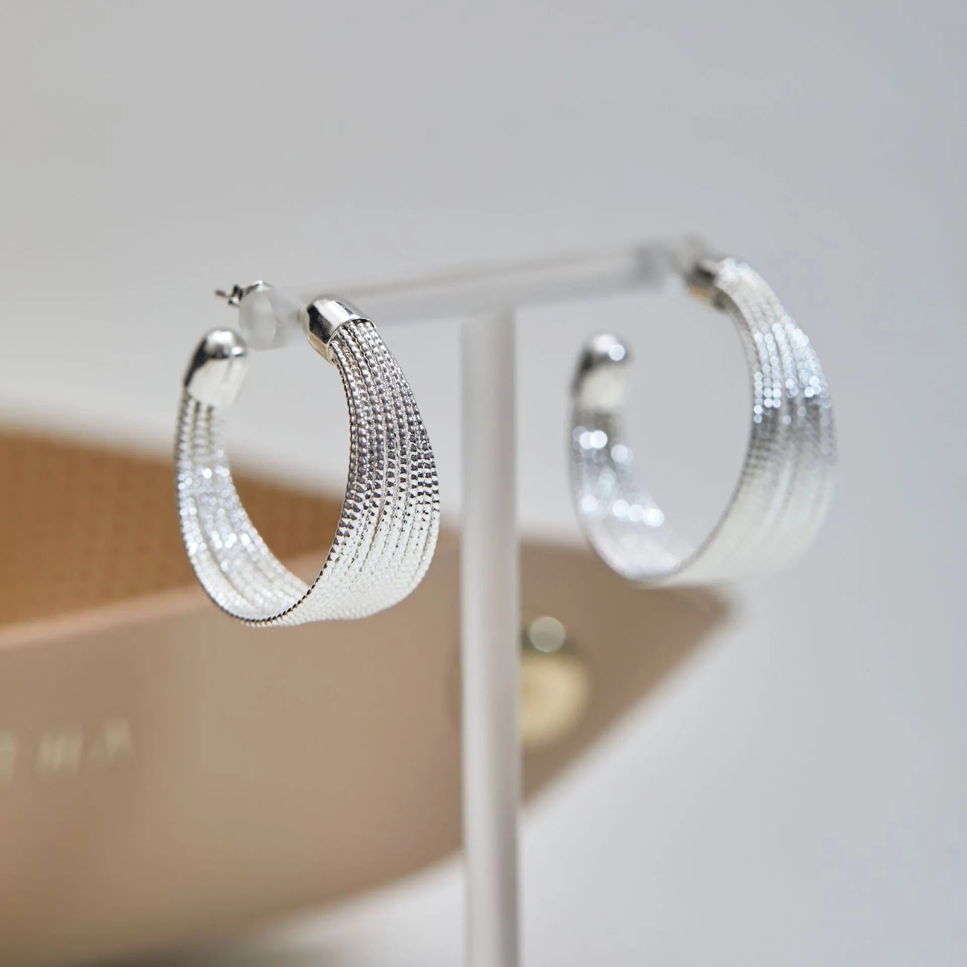Geometric multi-layer copper earrings with electroplated silver or gold finish, showing stud and clip-on design options