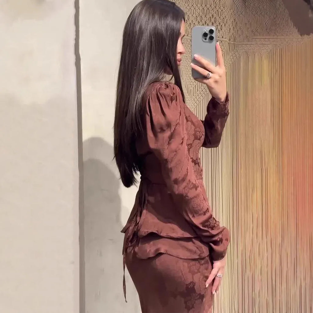 Dark brown retro dress with floral print, long sleeves, and fake two-piece design on mannequin