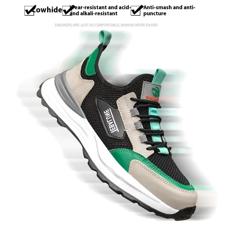Black and green low-top safety shoes with mesh panels and a steel toe cap on a white background.