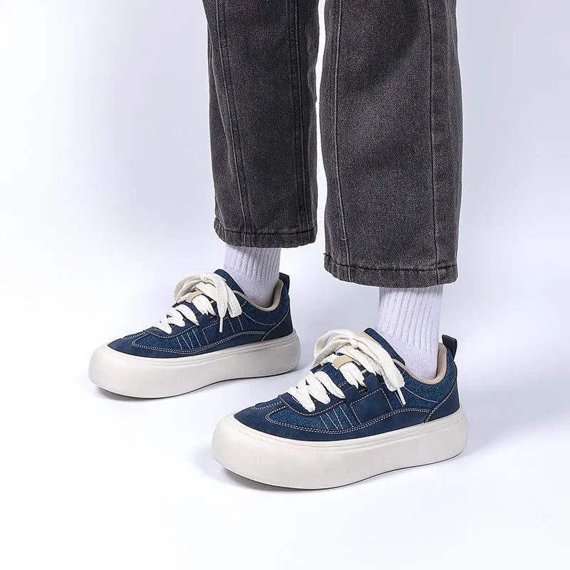 Men's black platform canvas shoes with round toe and lace-up front, showing raised heel design.