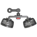 Black dual head plastic fan clipped to the back of a chair for outdoor cooling