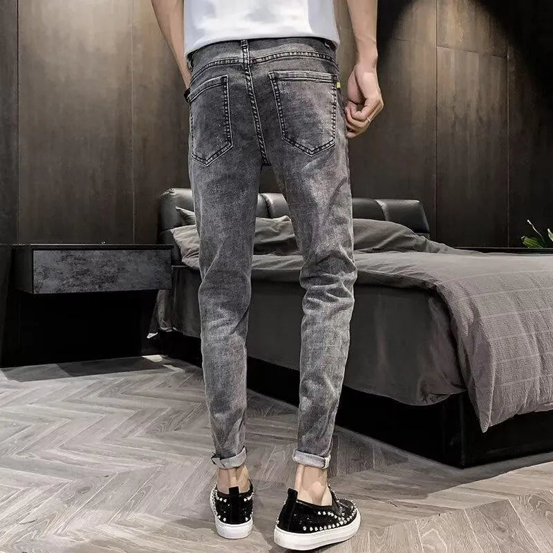 Men's high-waisted cotton denim jeans in a basic style with a button fly.
