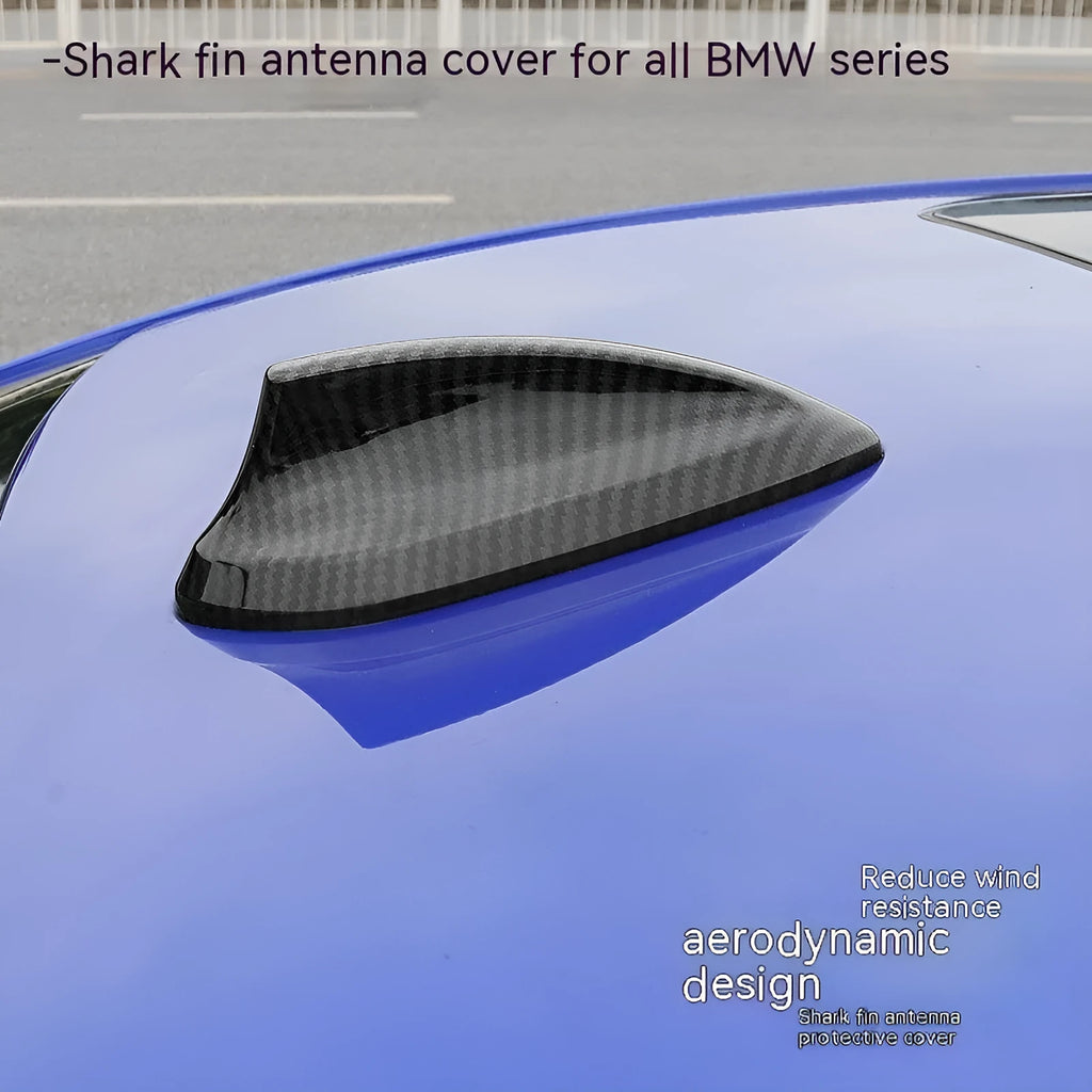 BMW shark fin antenna cover in carbon fibre and piano black finishes on a car roof.