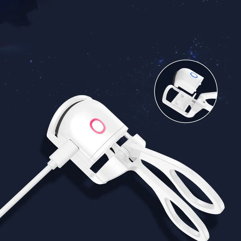 Pink and white USB rechargeable heated eyelash curler with dual temperature settings.
