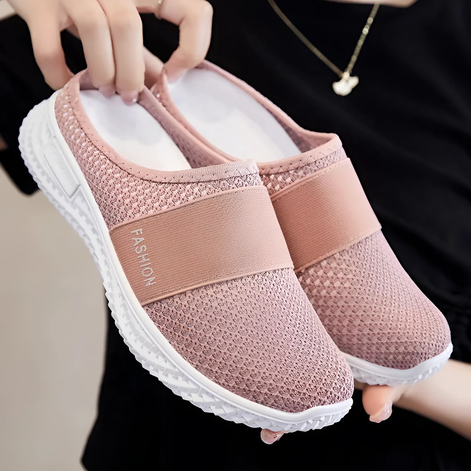 A pair of women's breathable casual flat shoes with a mesh upper and hollow-out design, shown in a choice of colours.