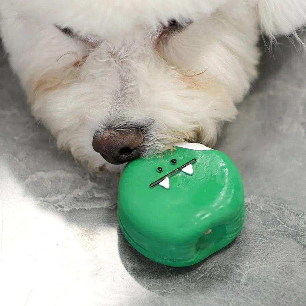 Yellow and green latex dog chew toy shaped like an egg bread with a cartoon puppy pattern.