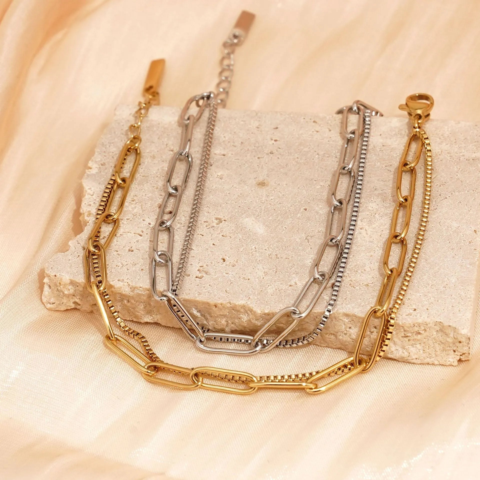 Double layer twin stainless steel bracelet in gold or silver with geometric line design.