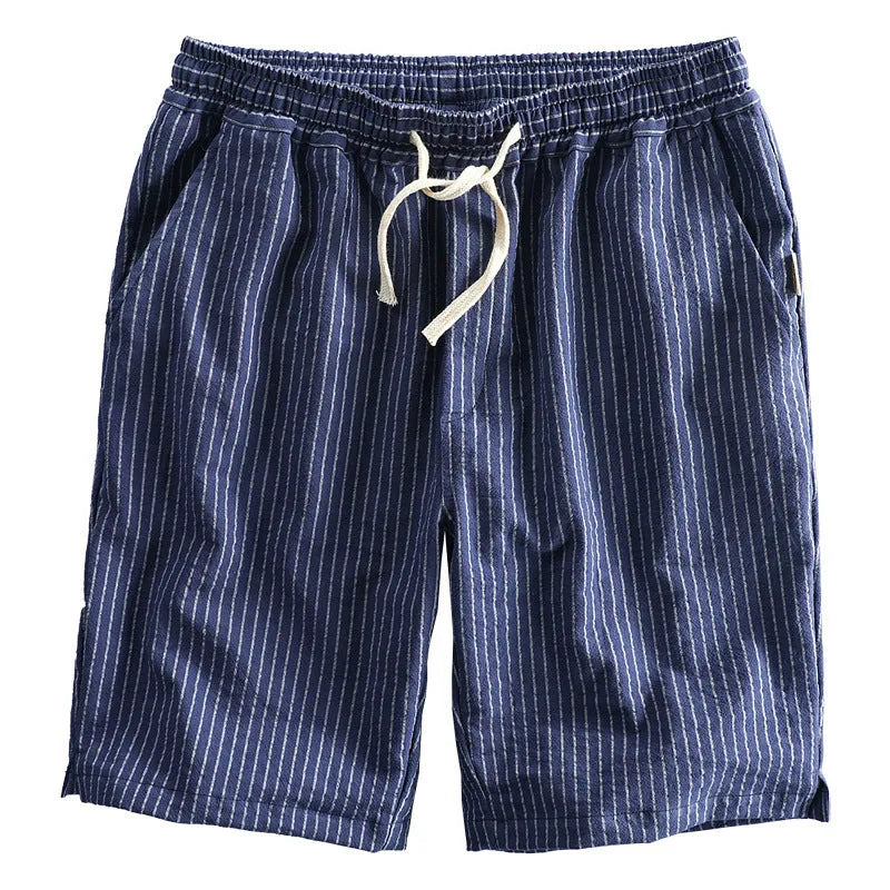 Men's striped cotton shorts in light blue with elastic waistband and micro elasticity, shown in a casual setting.