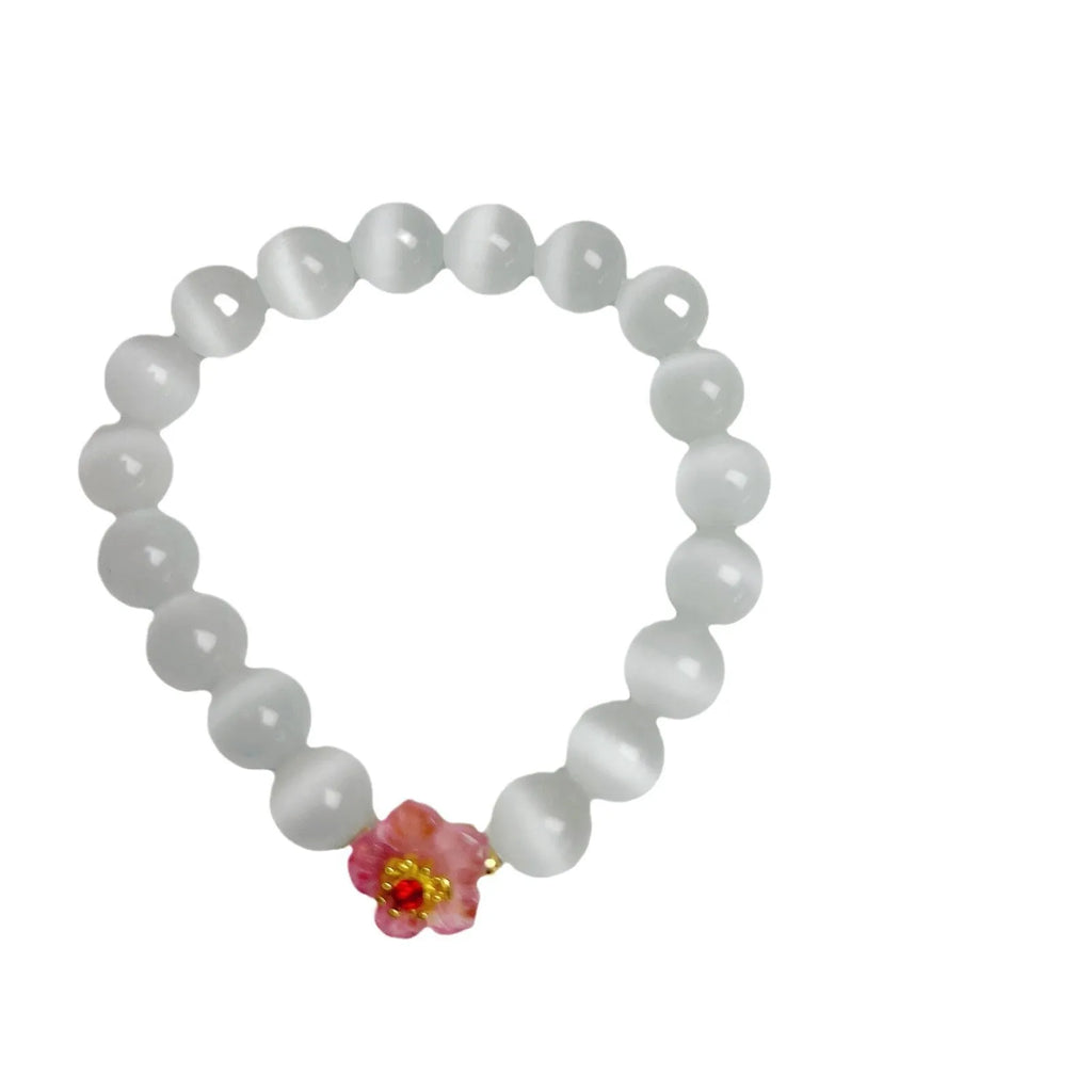 Handmade glass bead bracelet with floral designs in green, pink, white, or yellow colours