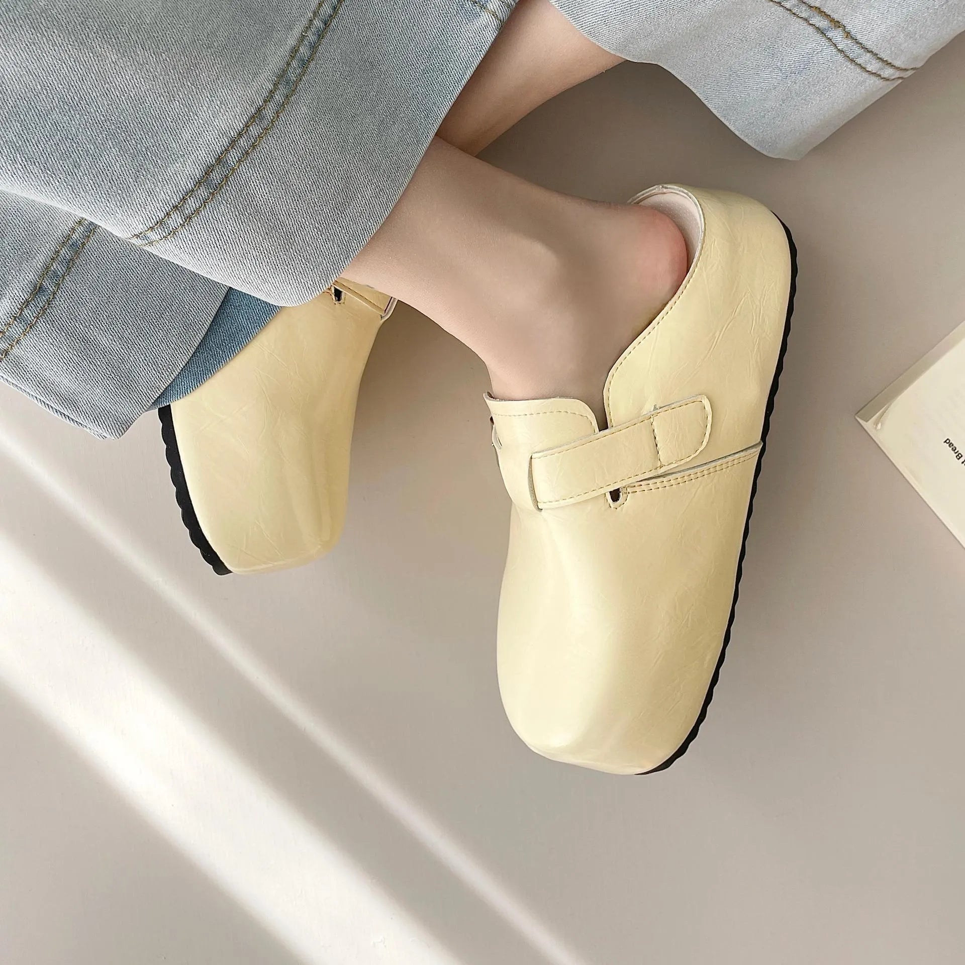 Flat buckle casual sneakers in yellow, creamy-white, silver, and black colours, showing round toe and PU upper.