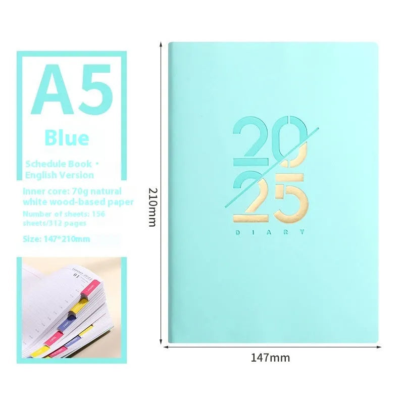 2025 A5 schedule book with faux leather cover in blue, showing open pages on a desk