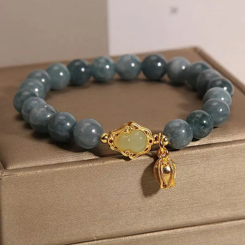 Sky blue natural stone bracelet with carved lotus and gourd pendant on electroplated brass setting