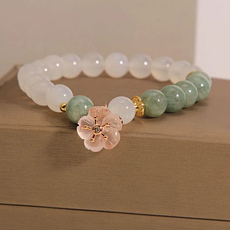 White agate jade bracelet with pink floral detailing and adjustable fastening