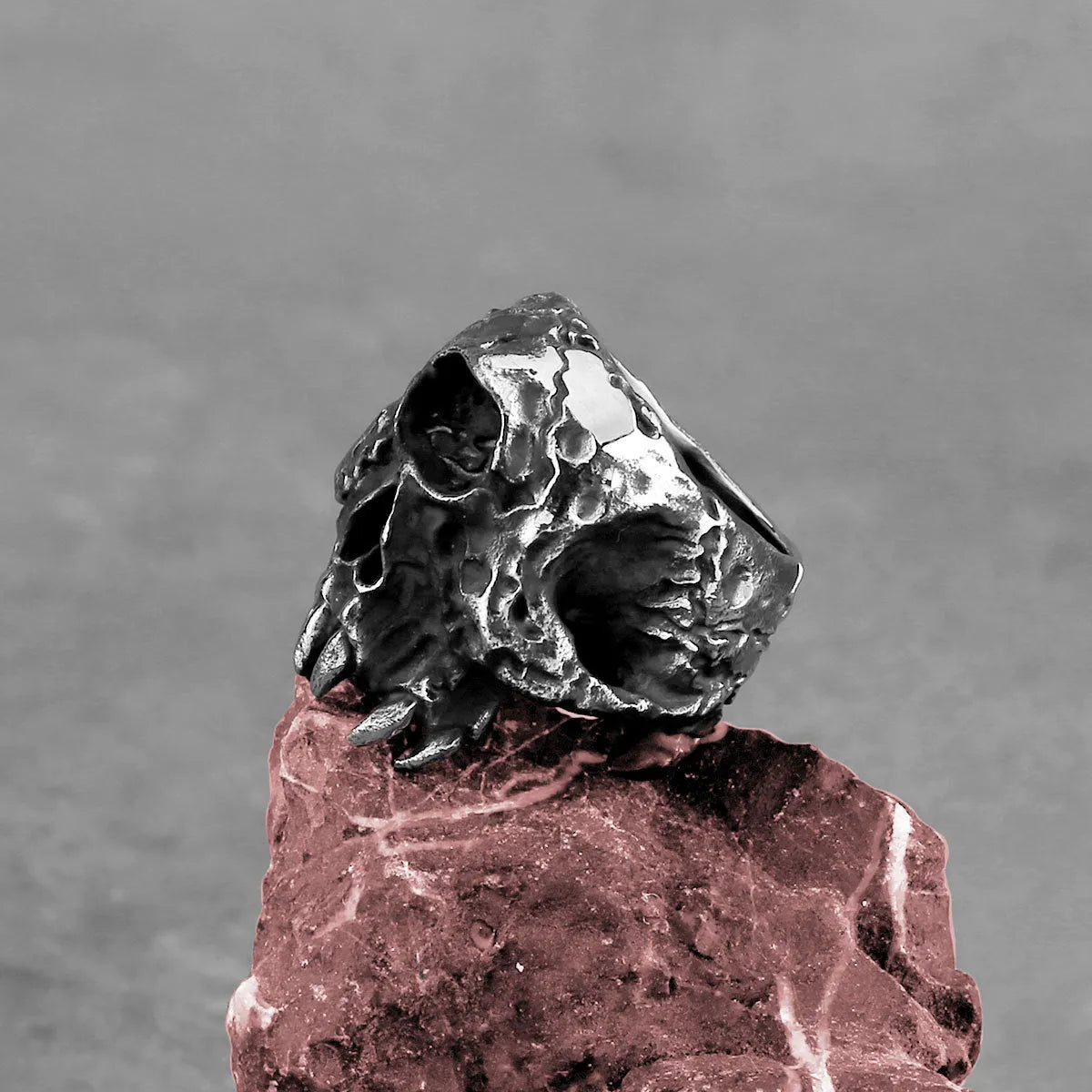 Alloy skull ring with one-eyed design and electroplated finish, shown in UK sizes 7-13 for retro punk style