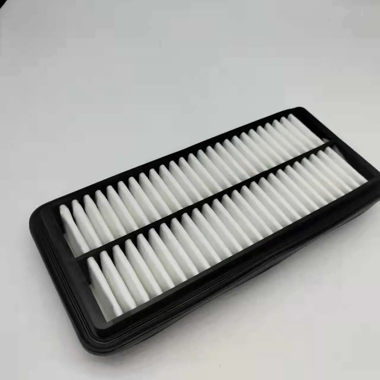 Black car air filter with dimensions 256mm by 113mm by 40mm for Modern vehicles