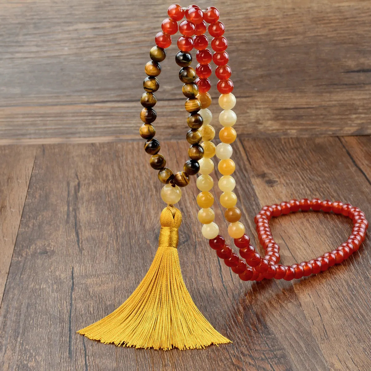 Long beaded bohemian necklace with 108 gemstone tassel pendants on a ball chain.