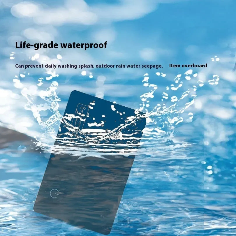 Black ultra-thin anti-loss alarm card for Apple devices on a table.