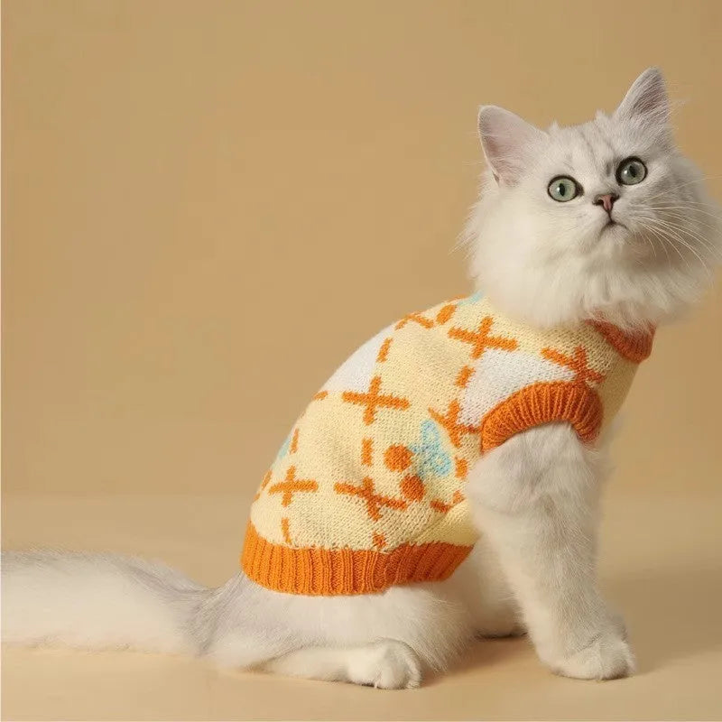 Orange knitted cat sweater with a cherry pattern, sized for small to large cats in autumn and winter.