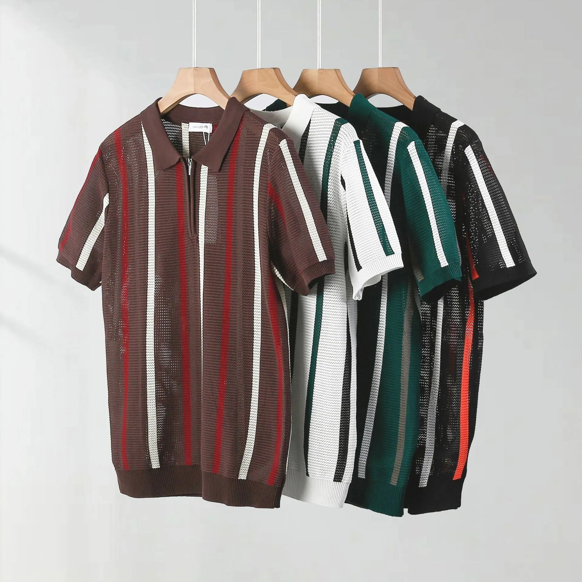 Man wearing a loose-fit black short-sleeved polo shirt with a mesh knit pattern and zipper decoration detail.