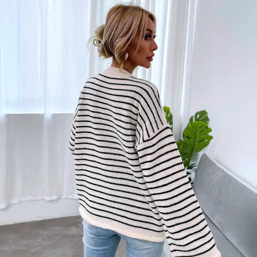 Black and white striped women's long-sleeve viscose top with drop-shoulder sleeves and a button detail.