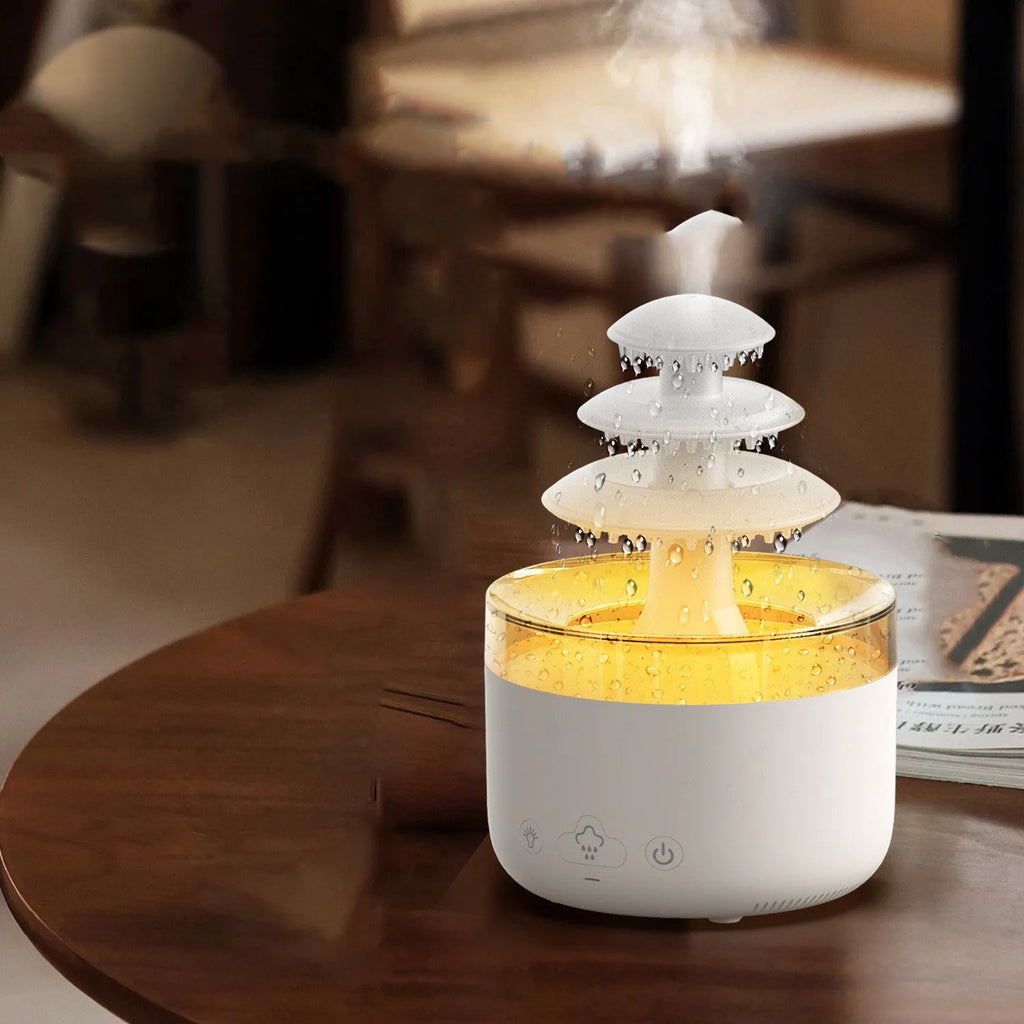 White Cloud Rain ultrasonic humidifier and essential oil diffuser with colourful LED lights on a table.