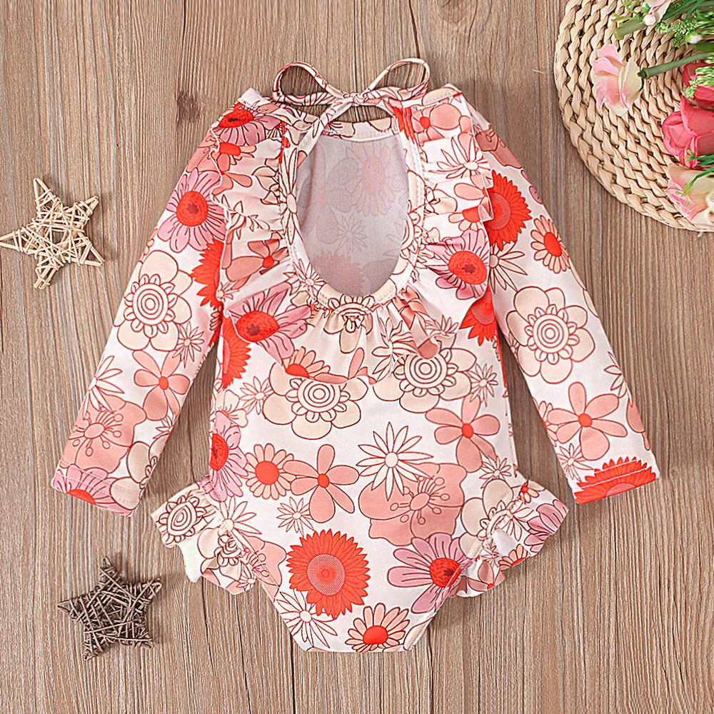 Girl's floral pattern open back swimsuit in polyester fabric showing crew neck design