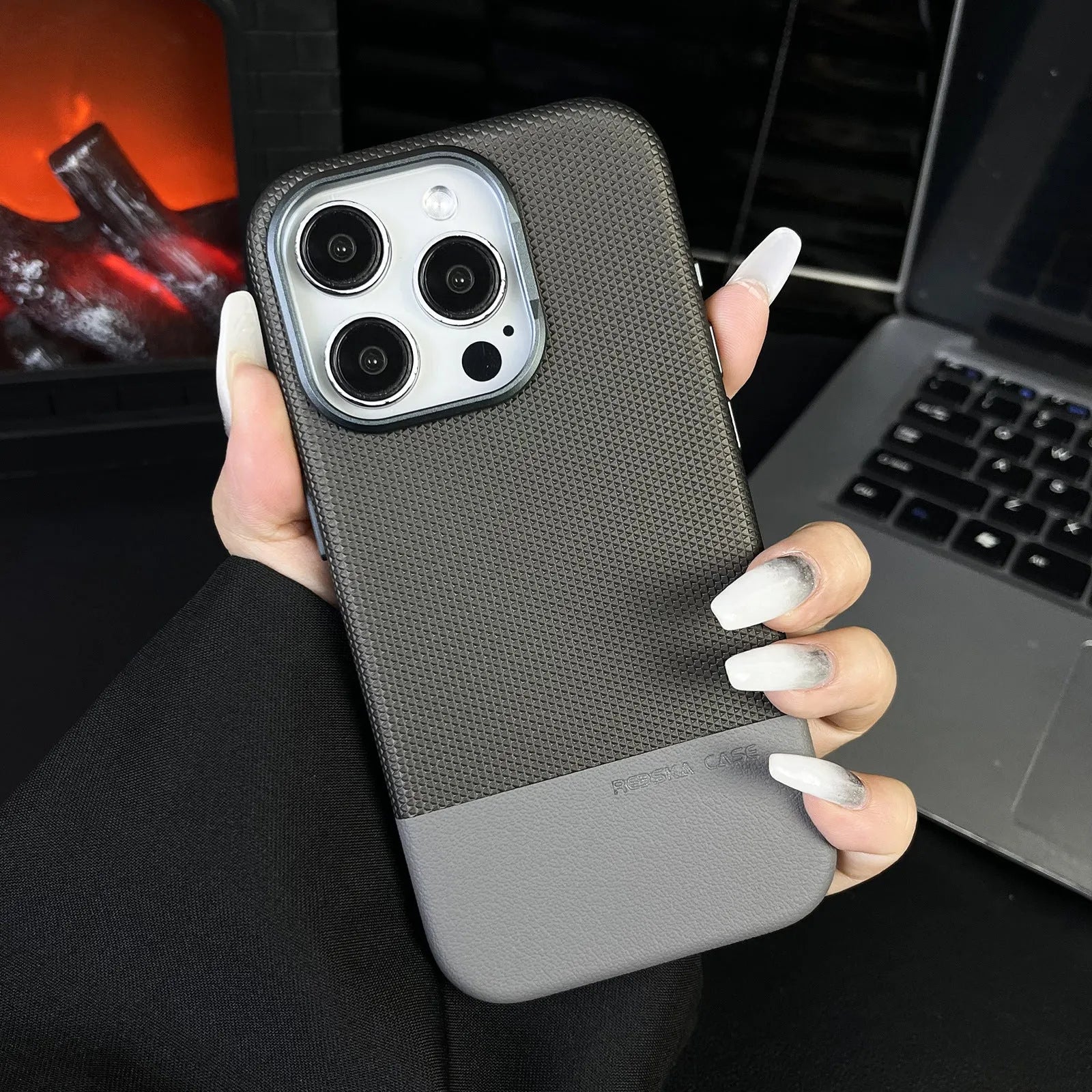 iPhone magnetic phone case with dragon scale texture and stitching detail in black, grey and green colours