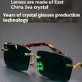 Dark green frameless crystal glasses with UV400 protection on a case