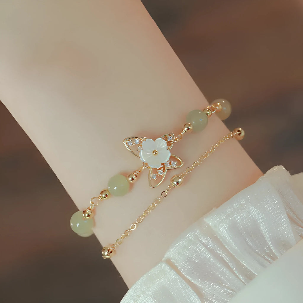 Yellow gold electroplated copper bracelet with butterfly charm and geometric shape for women.