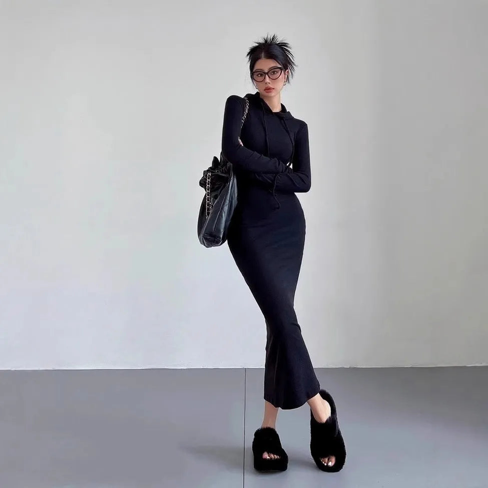 Women's grey hooded sheath dress with over-the-knee length and long sleeves showing high waist design