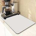 Square 60x90 cm rubber kitchen draining pad in blue checked pattern on countertop