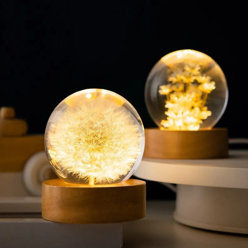 6cm diameter resin crystal ball with preserved dandelion flowers on beech wood stand, USB cable connected