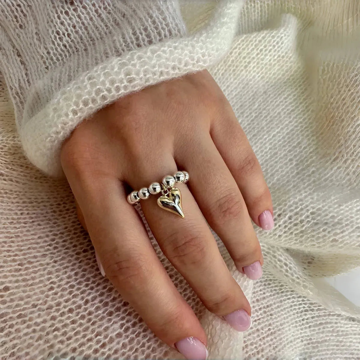 Handmade beaded elastic love ring with geometric heart design in gold and white colour options