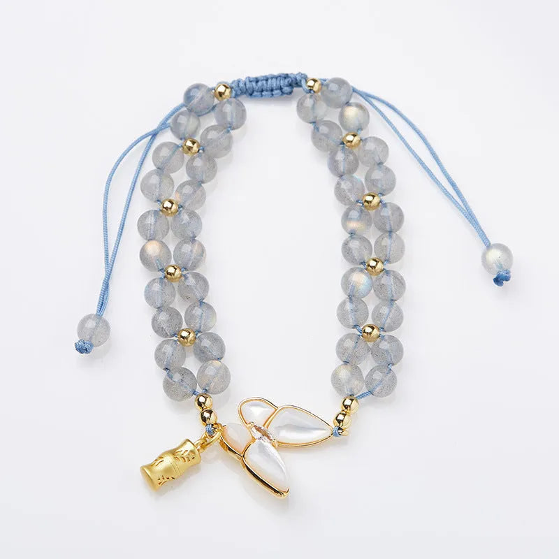 Grey moonstone bracelet with butterfly weave pattern on woven cord