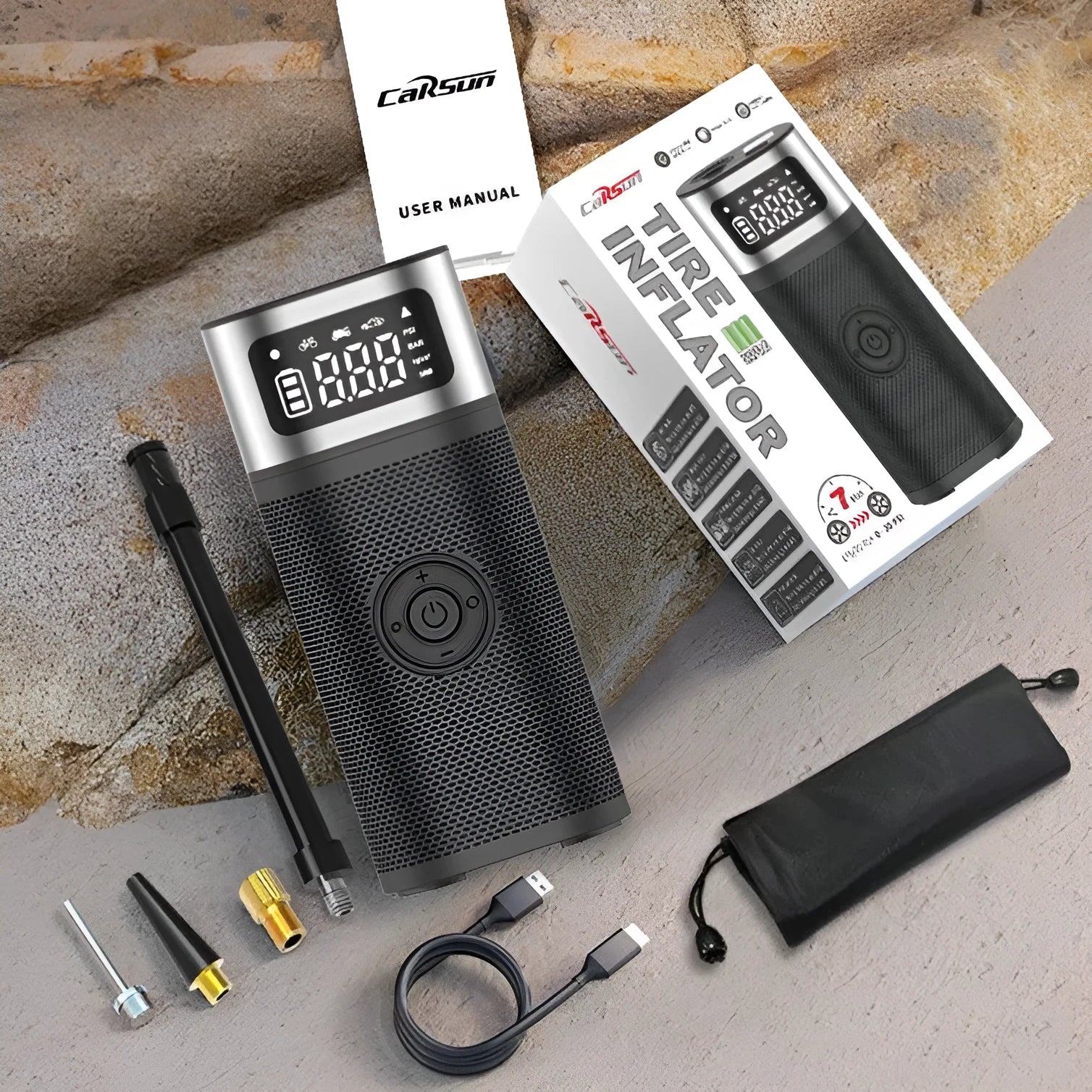 Black portable wireless smart air pump with LCD screen, LED light, inflation tube, and multiple nozzles on a white background.