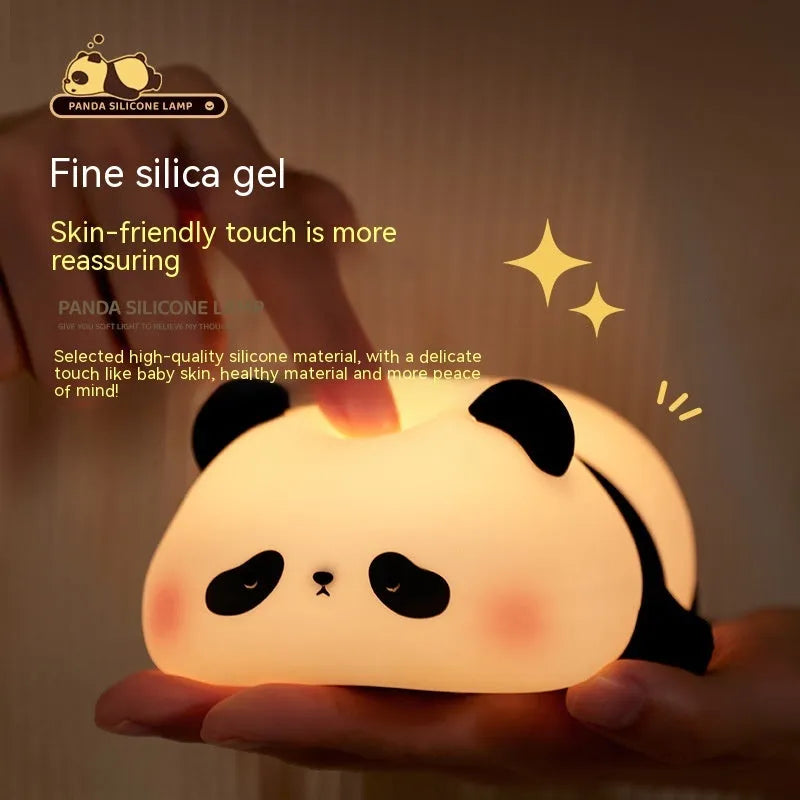 Panda-shaped night light with soft silicone surface, measuring 150x130x80mm, showing warm white glow