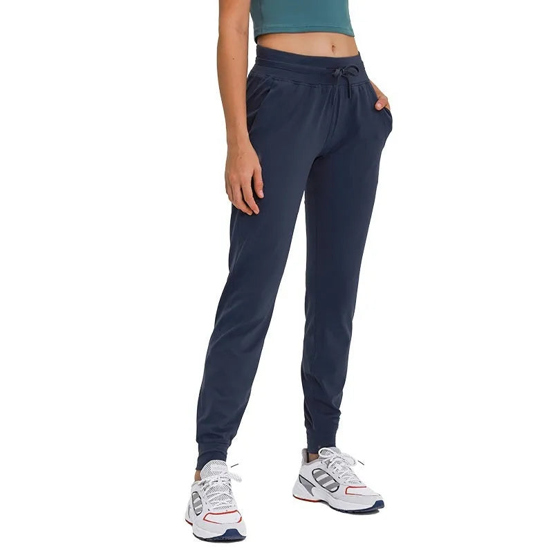 Women's high waist yoga pants with drawstring waistband in Belgian blue colour, showing elastic fit for exercise