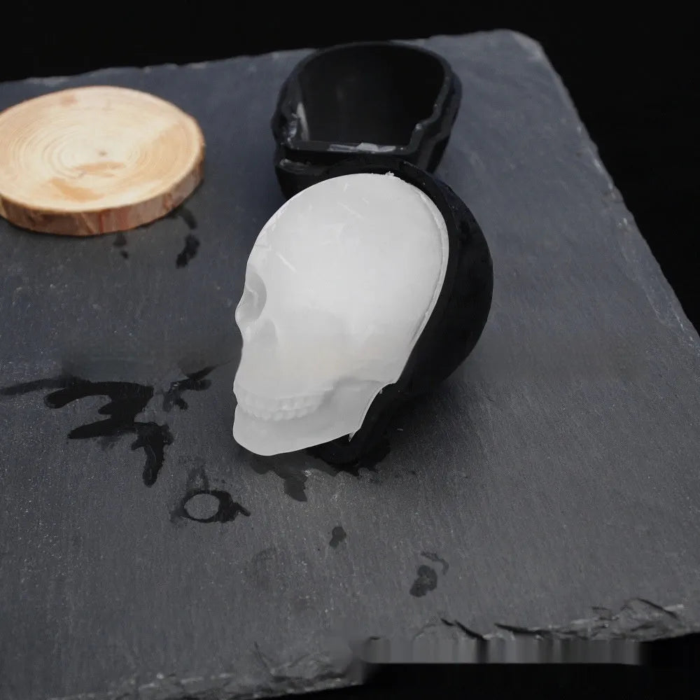 3D Halloween skull ice cube tray made from blue food-grade silicone, showing detailed mould cavities.