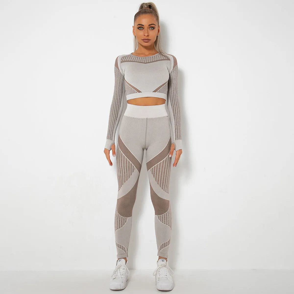 Women's long-sleeved seamless yoga suit in a striped pattern, shown in a stretch fabric suitable for exercise.