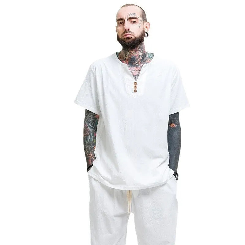 Man wearing a loose apricot coloured cotton linen blend t-shirt, showing the relaxed short sleeve pullover style.